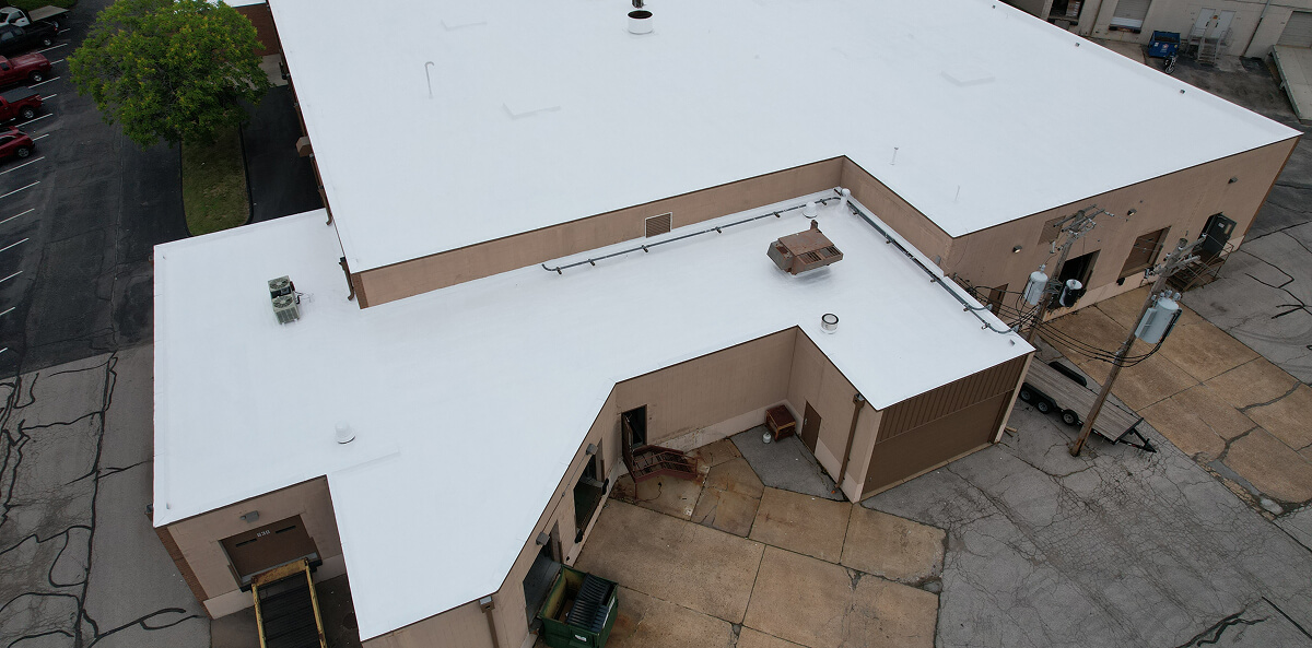 Completed white commercial flat roof after restoration — same Northwest Ohio building