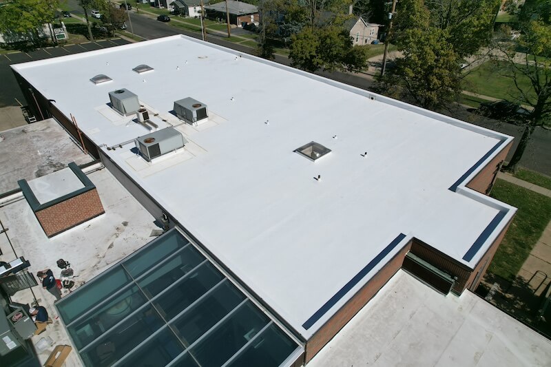 Completed white TPO commercial flat roof with skylights and HVAC units — aerial drone view Toledo Ohio